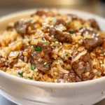 Overhead view of a bowl of onion beef fried rice